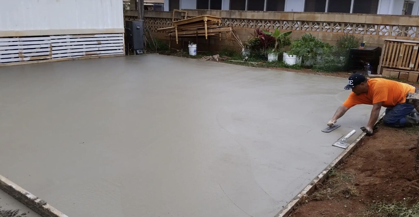 Concrete contractor hand-troweling a freshly poured residential concrete floor in Camarillo, CA